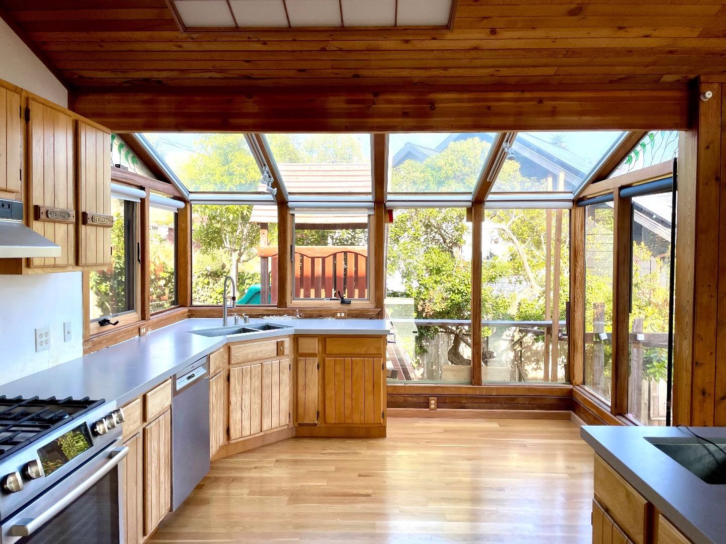 490 Talbot Avenue Pacifica, CA 94044 - Photo 3 of 12 a kitchen with stainless steel appliances wooden cabinets a stove and a large window