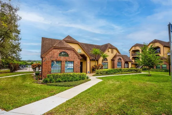 a front view of house with yard and green space
