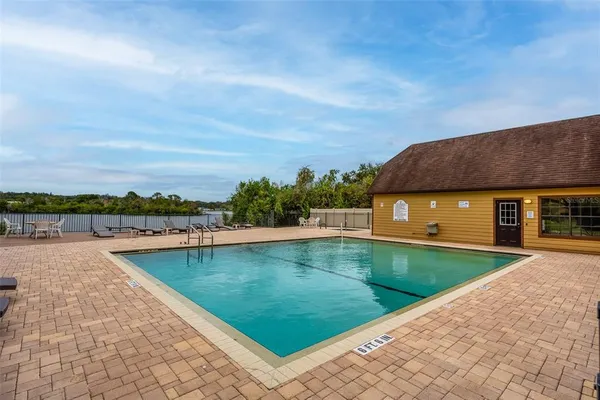 a view of a swimming pool with lounge chair