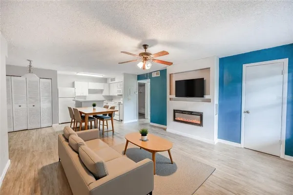 a living room with furniture a fireplace and a flat screen tv