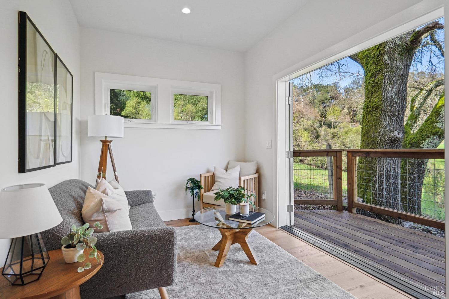 19129-19131 Spring Drive Sonoma, CA 95476 - Photo 19 of 29 a living room with furniture floor to ceiling window and wooden floor