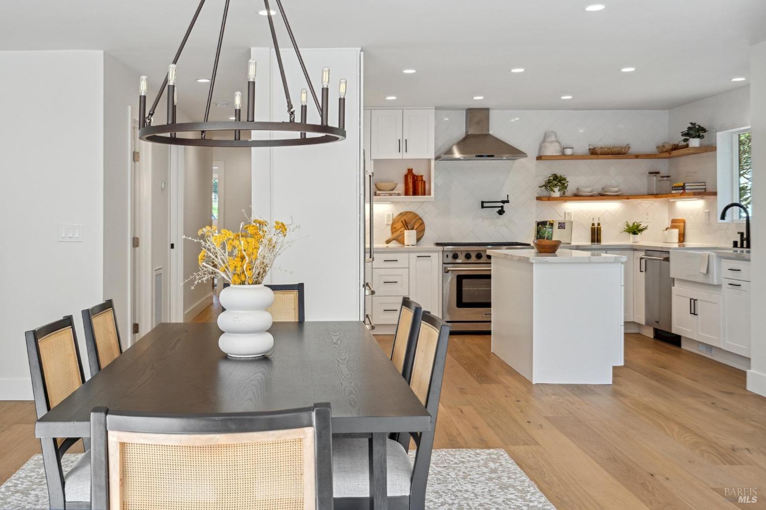 19129-19131 Spring Drive Sonoma, CA 95476 - Photo 6 of 29 a kitchen with stainless steel appliances granite countertop a sink a stove a microwave a dining table and chairs