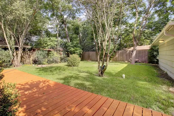a view of a backyard with large trees