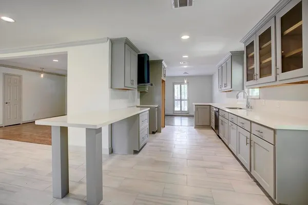a large kitchen with stainless steel appliances kitchen island granite countertop a large counter top and cabinets