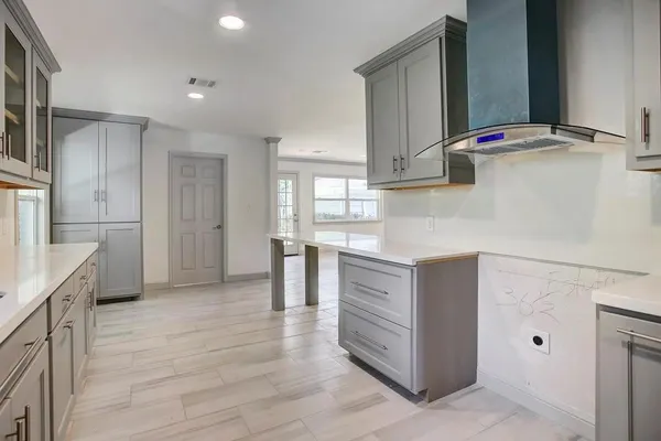 a kitchen with kitchen island cabinets and oven