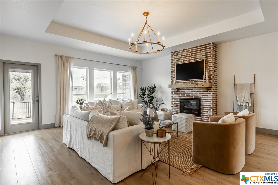 a living room with fireplace furniture and a flat screen tv