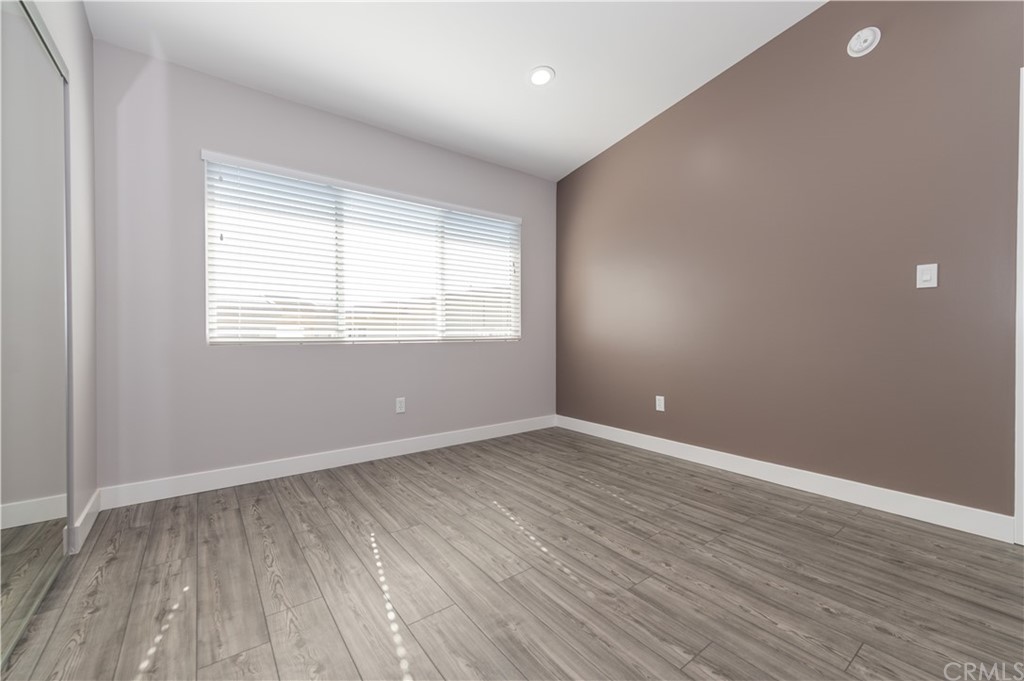 5 Clipper Road, Unit B Rancho Palos Verdes, CA 90275 - Photo 15 of 20 an empty room with wooden floor and windows