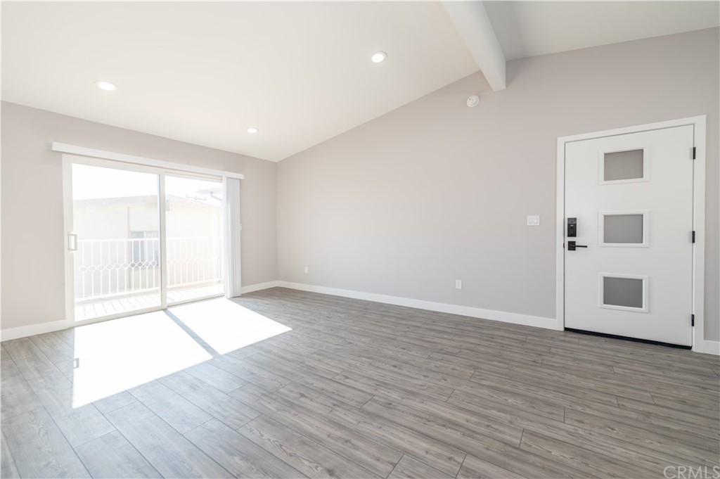 5 Clipper Road, Unit B Rancho Palos Verdes, CA 90275 - Photo 8 of 20 an empty room with wooden floor and windows