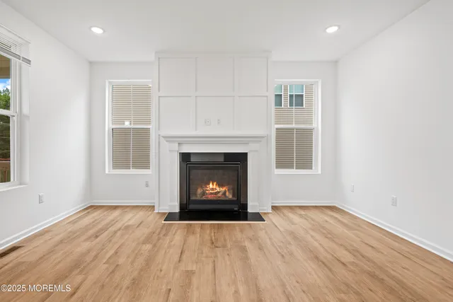 a kitchen with granite countertop cabinets stainless steel appliances and wooden floor