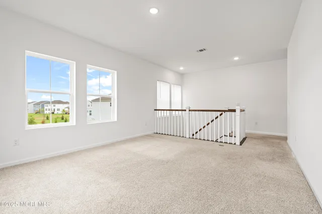a bedroom with two beds and a large window