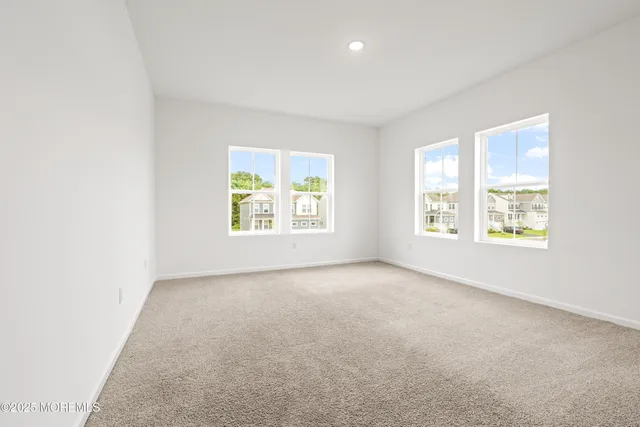 a bedroom with a large bed and a large window