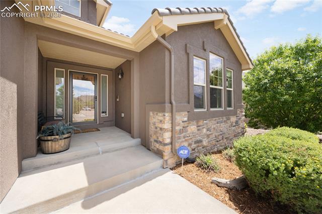 1131 Old North Gate Road Colorado Springs, CO 80921 - Photo 2 of 39 Entrance to home with stucco siding and stone