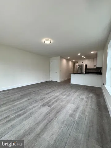 a view of a kitchen with a sink and a large window