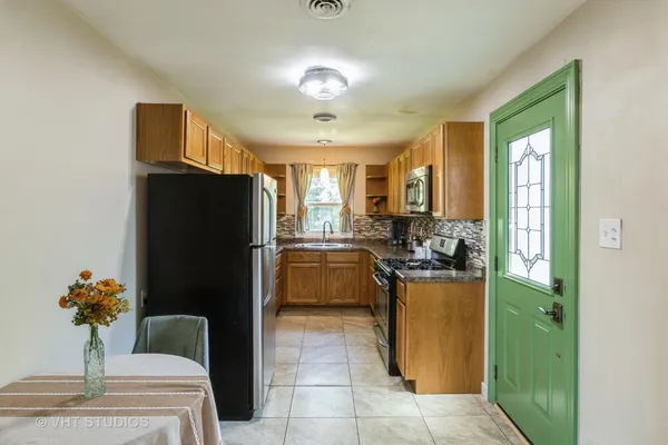 a kitchen with a refrigerator and a sink