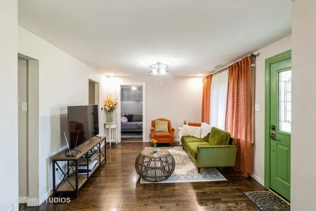 a living room with furniture wooden floor and a flat screen tv