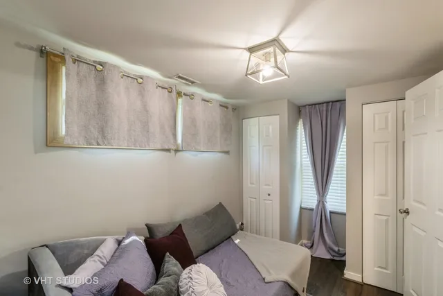 a bedroom with a bed and a chandelier