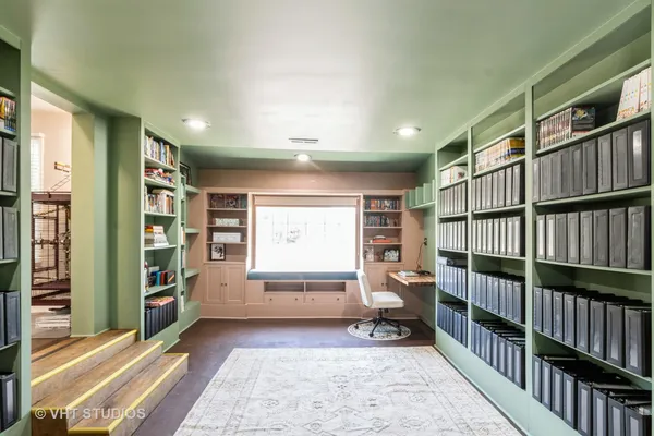 a bedroom with furniture and a book shelf