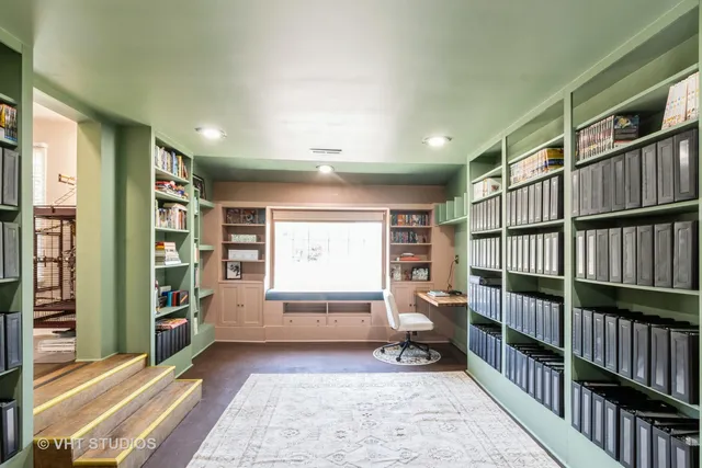 a bedroom with furniture and a book shelf