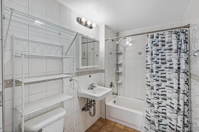a bathroom with a bathtub and shower