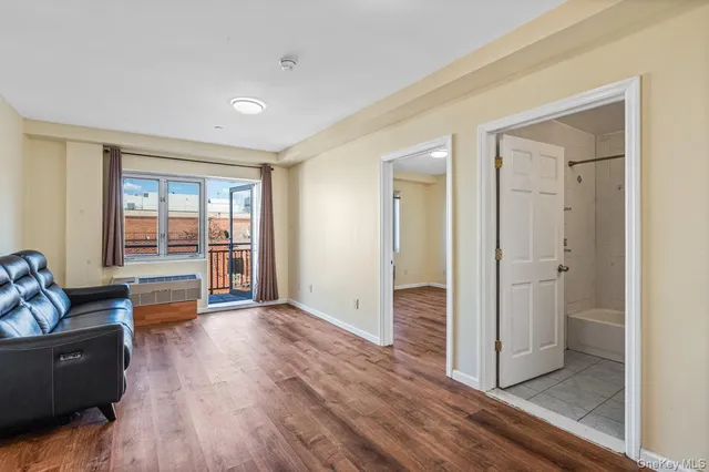 a view of room with window and wooden floor