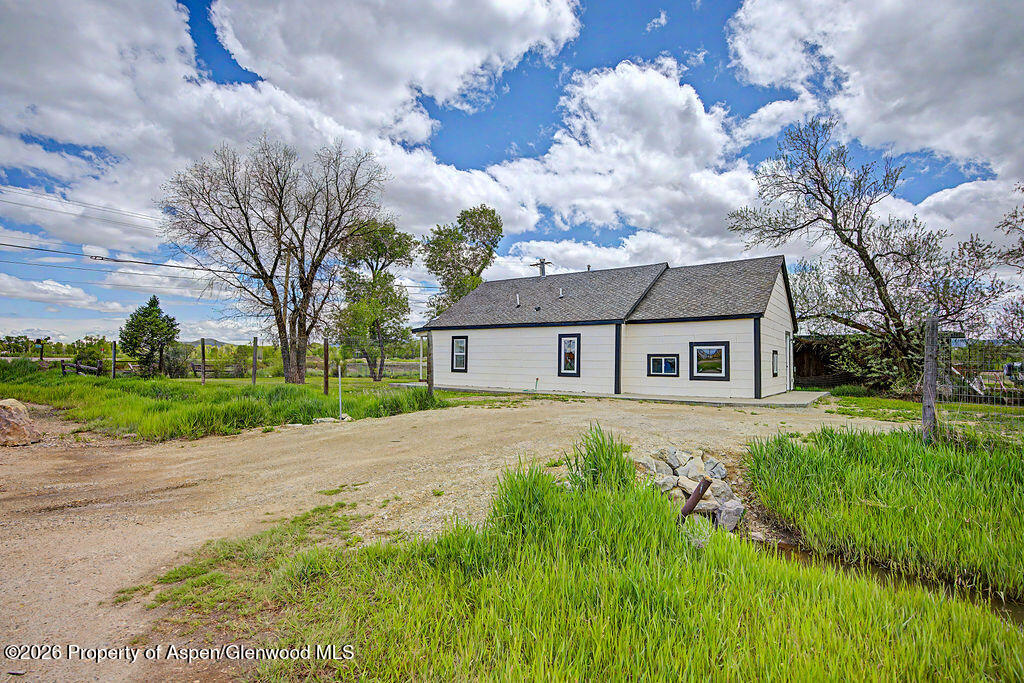 54 South Ranney Street Craig, CO 81625 - Photo 24 of 32 a front view of a house with garden