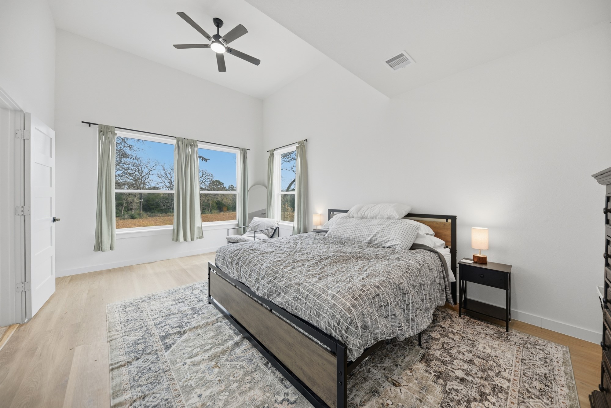 25504 Squirrel Road New Ulm, TX 78950 - Photo 11 of 37 a bedroom with a large bed and a window