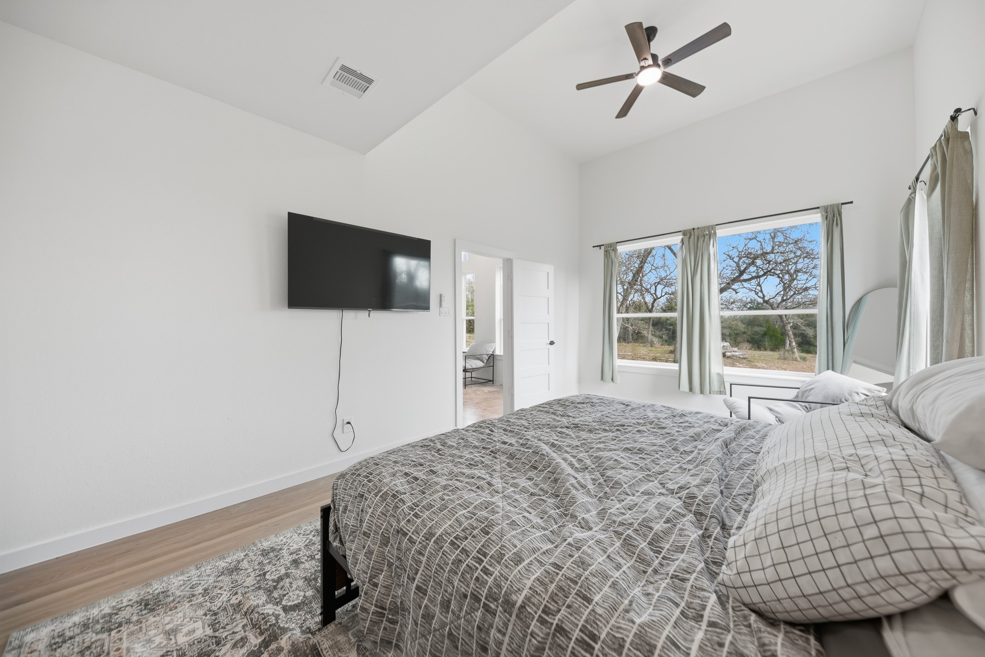 25504 Squirrel Road New Ulm, TX 78950 - Photo 12 of 37 a bedroom with a bed and a flat screen tv
