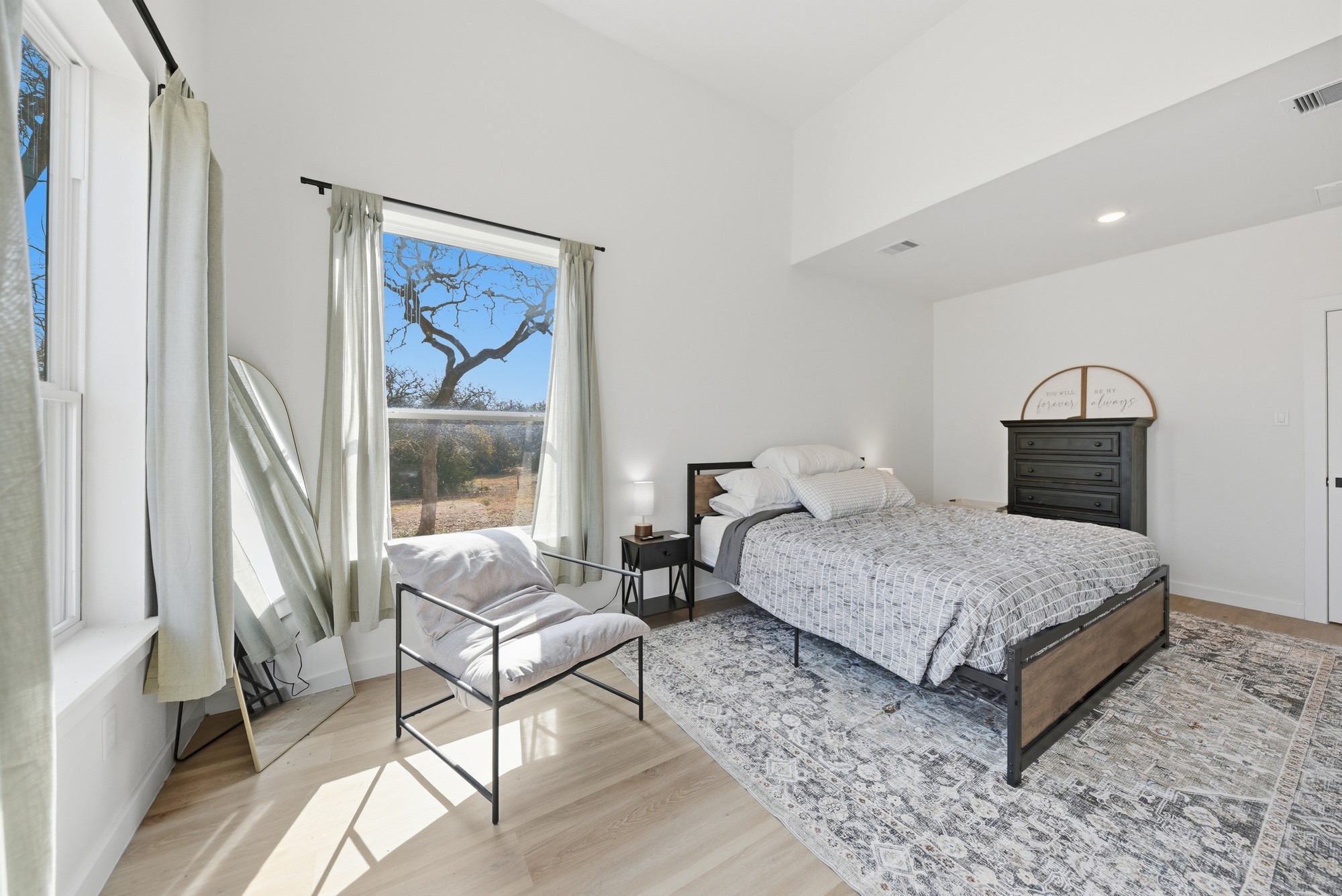 25504 Squirrel Road New Ulm, TX 78950 - Photo 13 of 37 a bedroom with a large bed and a window