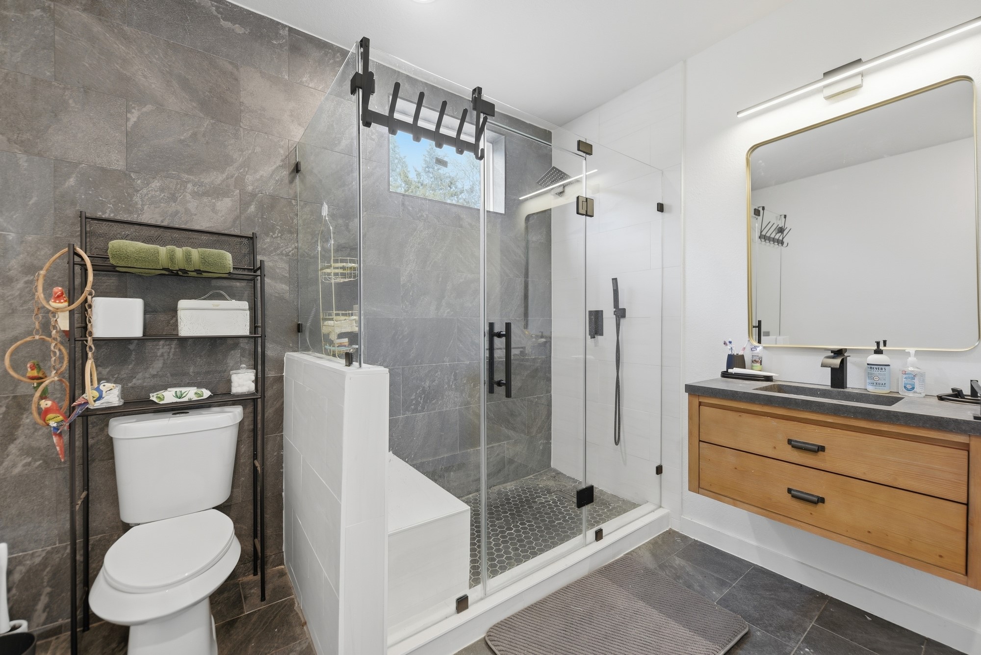 25504 Squirrel Road New Ulm, TX 78950 - Photo 15 of 37 a bathroom with a toilet sink vanity granite and shower