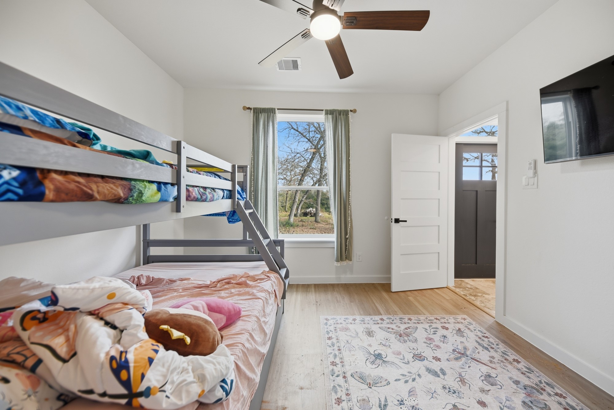 25504 Squirrel Road New Ulm, TX 78950 - Photo 16 of 37 a bedroom with a bed and a flat screen tv