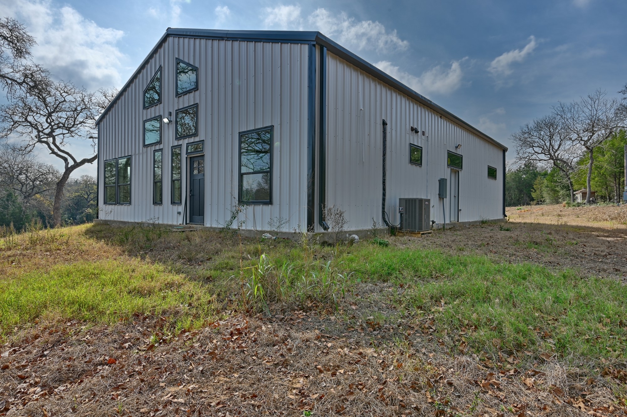 25504 Squirrel Road New Ulm, TX 78950 - Photo 2 of 37 a view of a house with backyard and trees