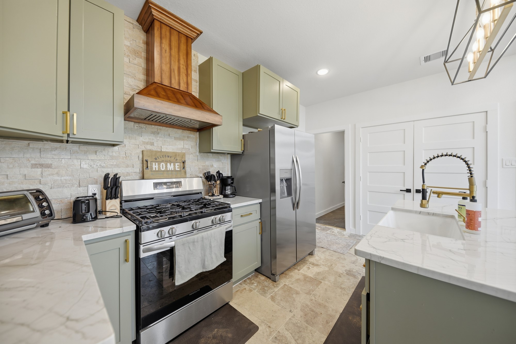 25504 Squirrel Road New Ulm, TX 78950 - Photo 8 of 37 a kitchen with stainless steel appliances granite countertop a sink stove and refrigerator
