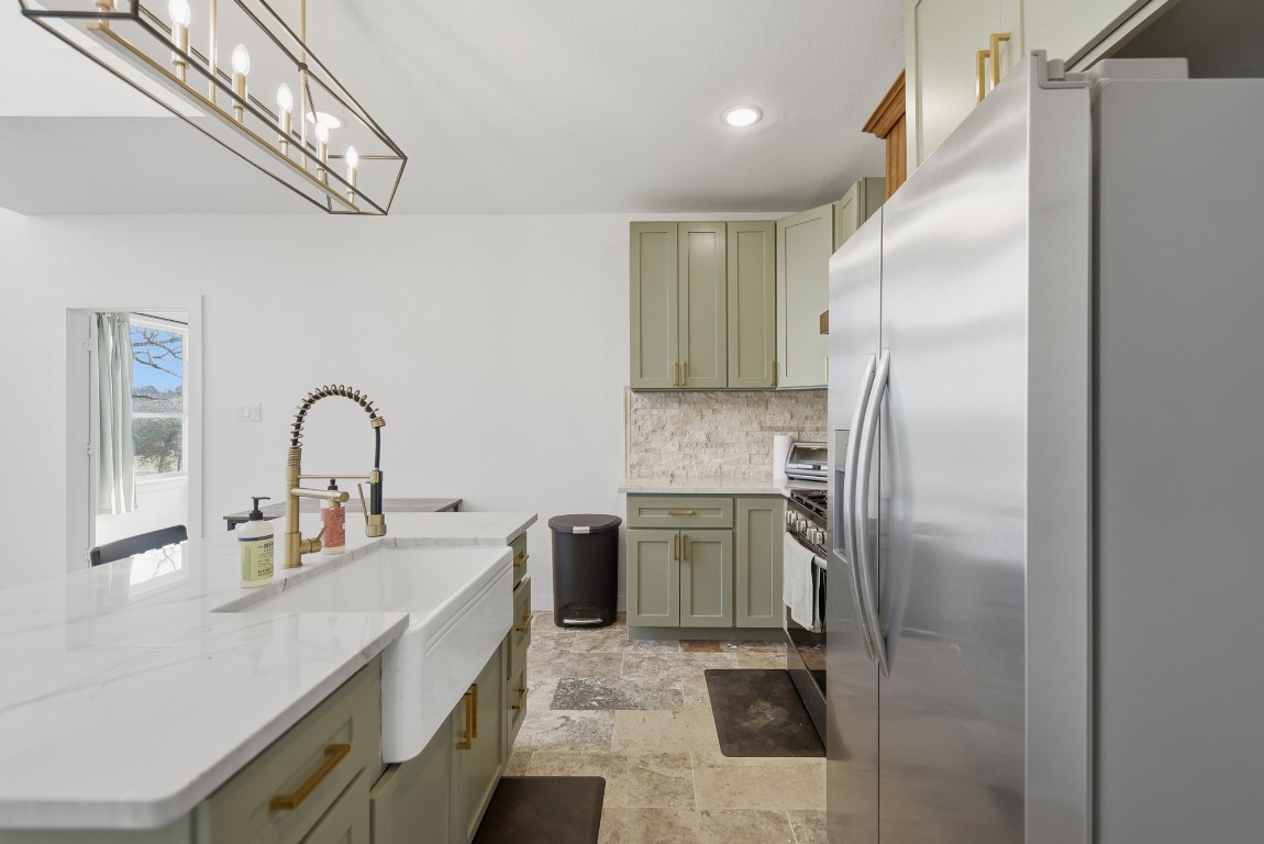 25504 Squirrel Road New Ulm, TX 78950 - Photo 9 of 37 a kitchen with stainless steel appliances granite countertop a refrigerator a sink and a stove
