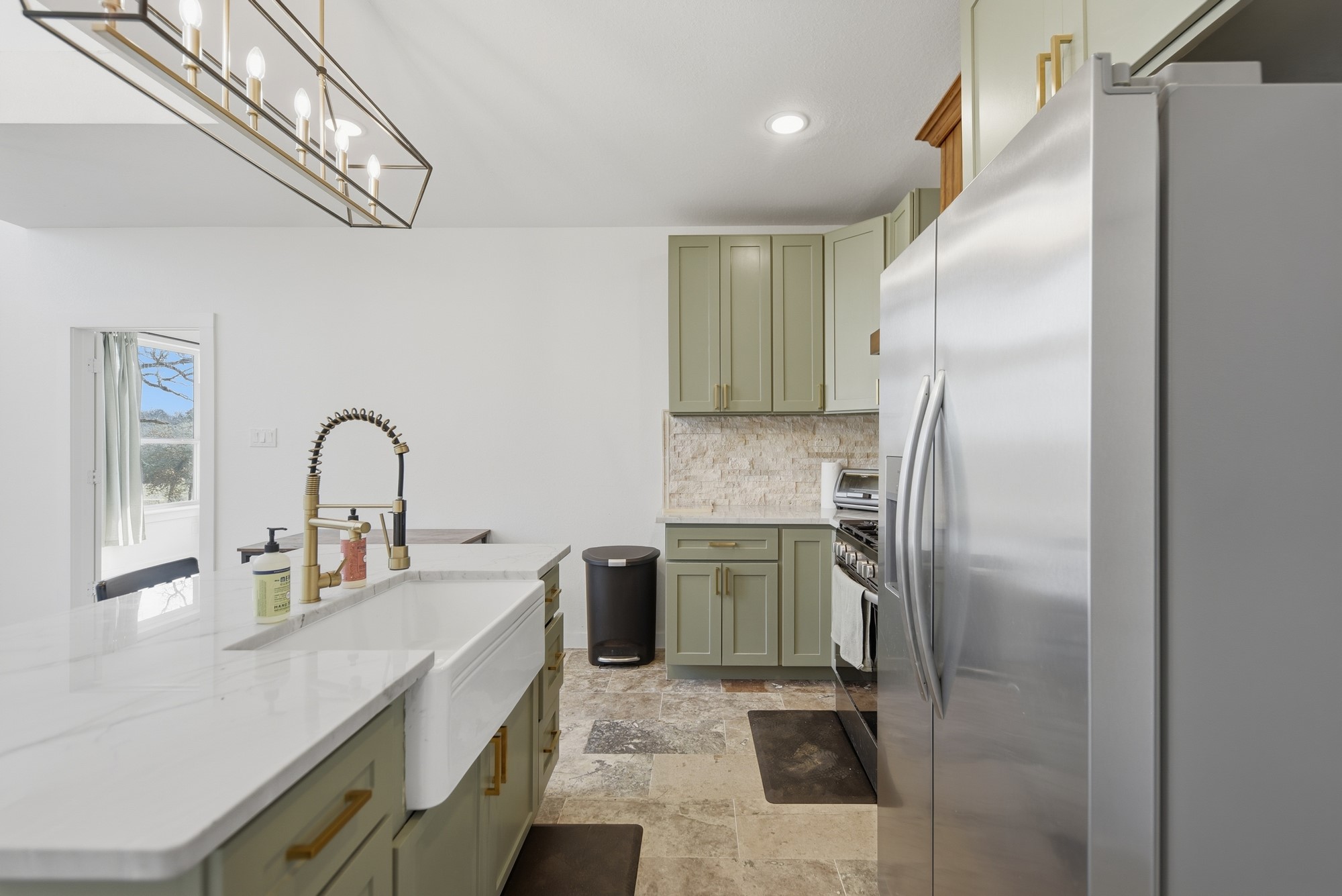 25504 Squirrel Road New Ulm, TX 78950 - Photo 9 of 37 a kitchen with stainless steel appliances granite countertop a refrigerator a sink and a stove