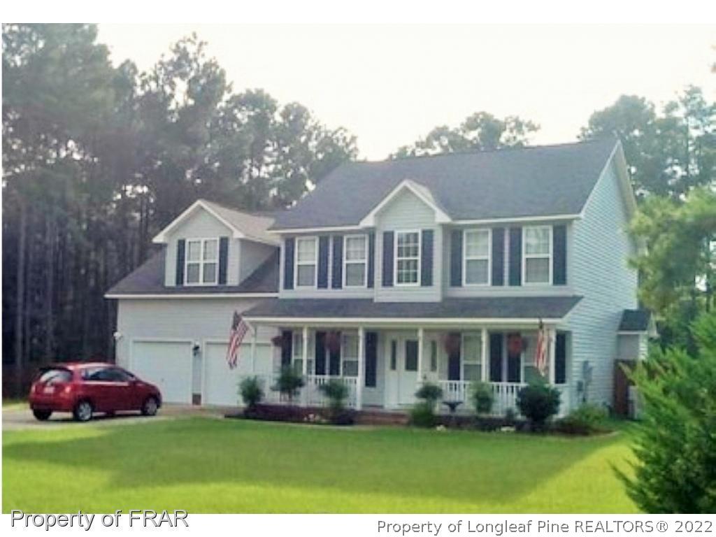 1149 Hoover Road Sanford, NC 27332 - Photo 2 of 15 a front view of a house with a garden and plants