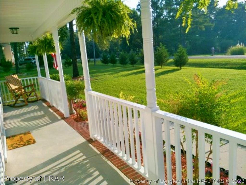 1149 Hoover Road Sanford, NC 27332 - Photo 3 of 15 a view of a deck with a big yard potted plants and large tree