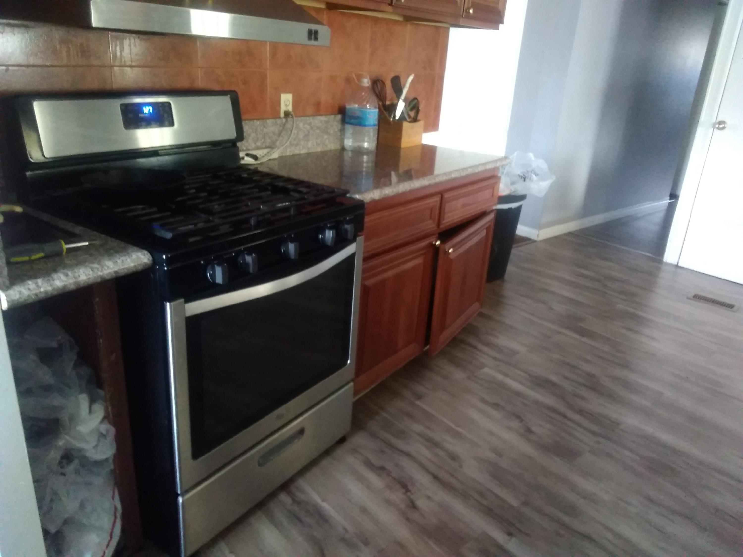 1855 East Riverside Drive Ontario, CA 91761 - Photo 11 of 13 a kitchen with wooden floors and a stove