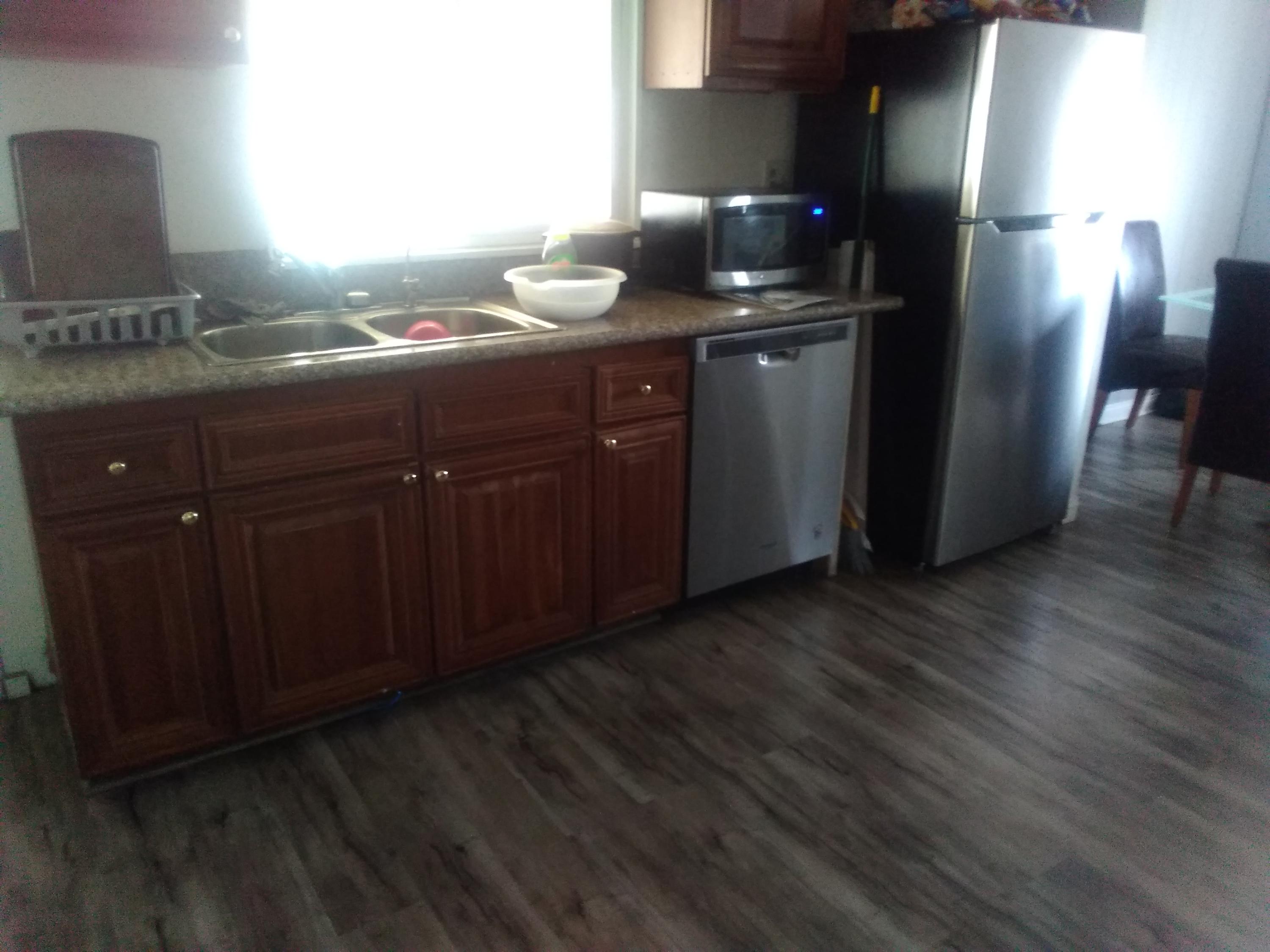 1855 East Riverside Drive Ontario, CA 91761 - Photo 12 of 13 a kitchen with stainless steel appliances granite countertop wooden cabinets and a granite counter tops