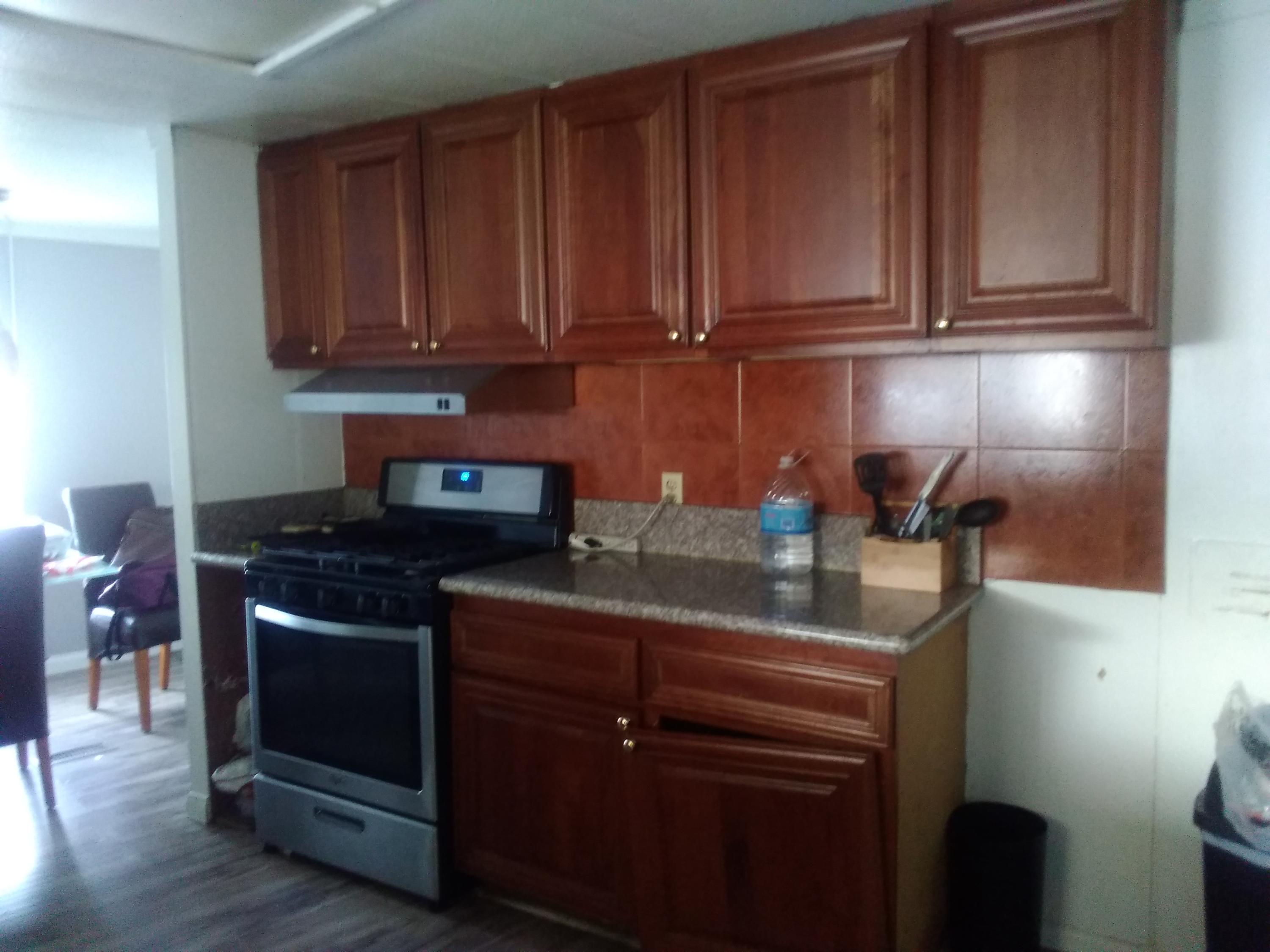 1855 East Riverside Drive Ontario, CA 91761 - Photo 13 of 13 a kitchen with stainless steel appliances granite countertop wooden cabinets and a stove top oven