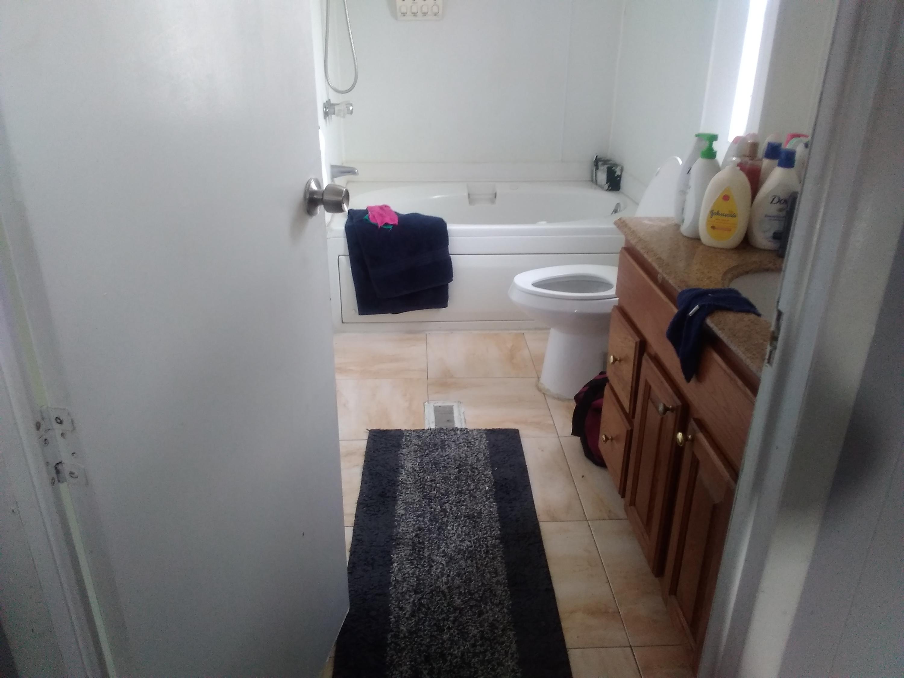 1855 East Riverside Drive Ontario, CA 91761 - Photo 8 of 13 a bathroom with a toilet and a shower