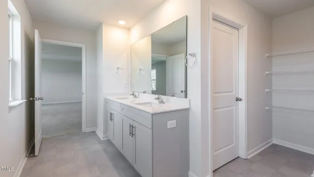 a bathroom with a sink and mirror