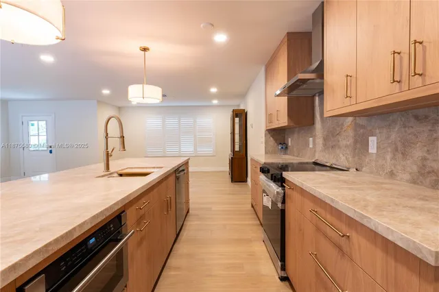a kitchen with a sink stove and cabinets