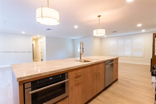 a kitchen with a sink and chandelier