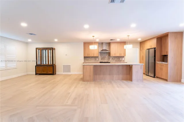 a view of kitchen with wooden floor