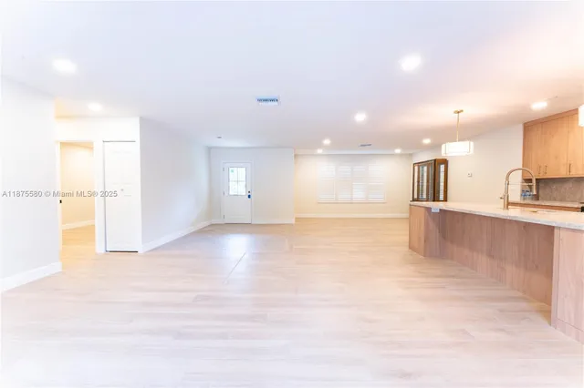 a view of a kitchen with a sink and a stove top oven