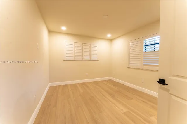 a view of a room with a wooden floor and a window
