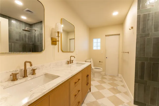 a bathroom with a sink double vanity and a shower