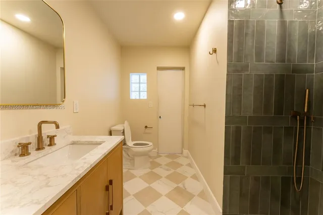 a bathroom with a sink toilet and shower