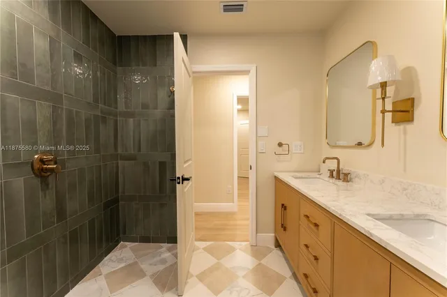 a bathroom with a granite countertop sink mirror and shower