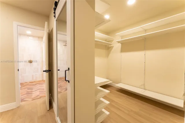 a bathroom with a shower and a glass door